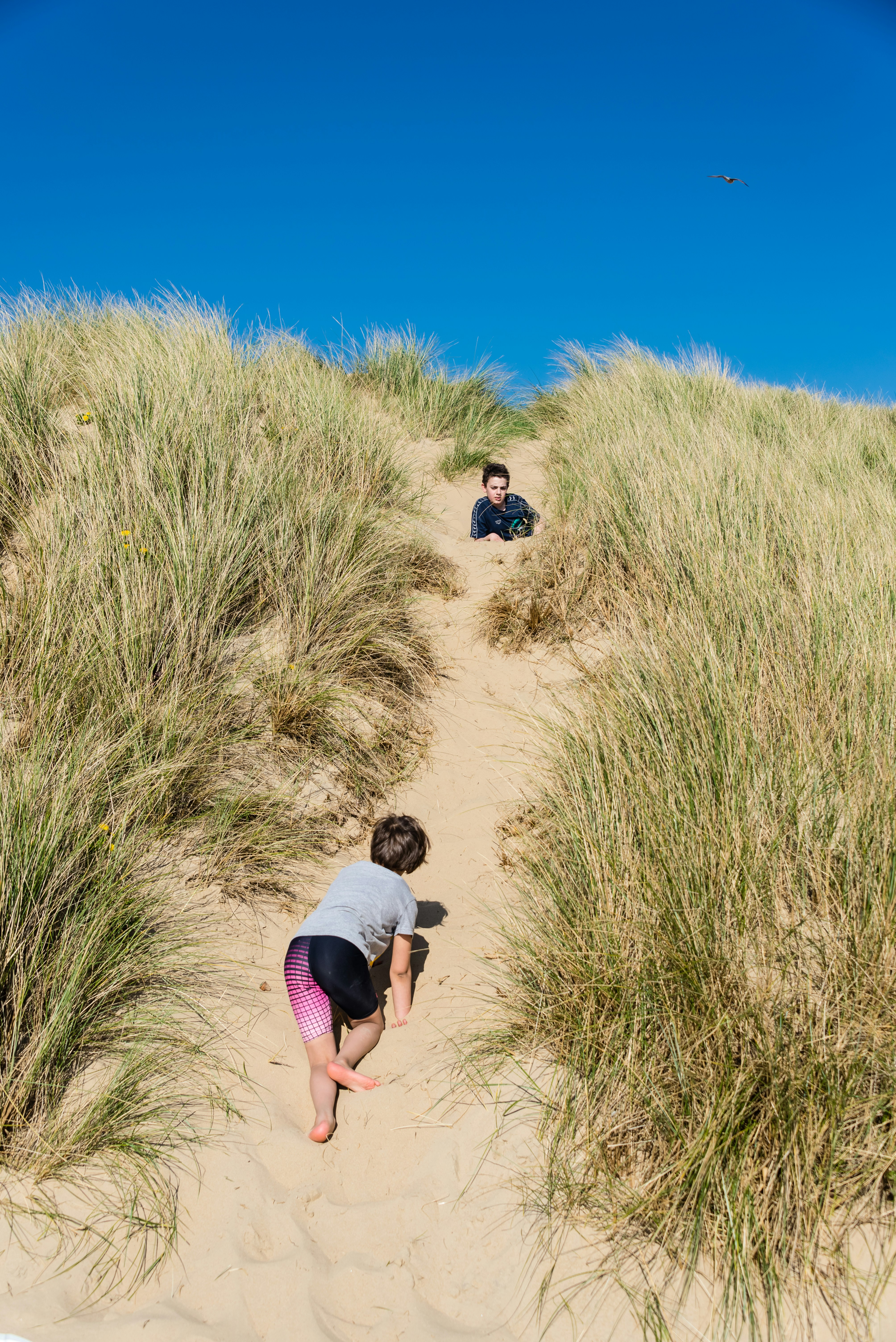 Children exploring the dunes at Camber Sands